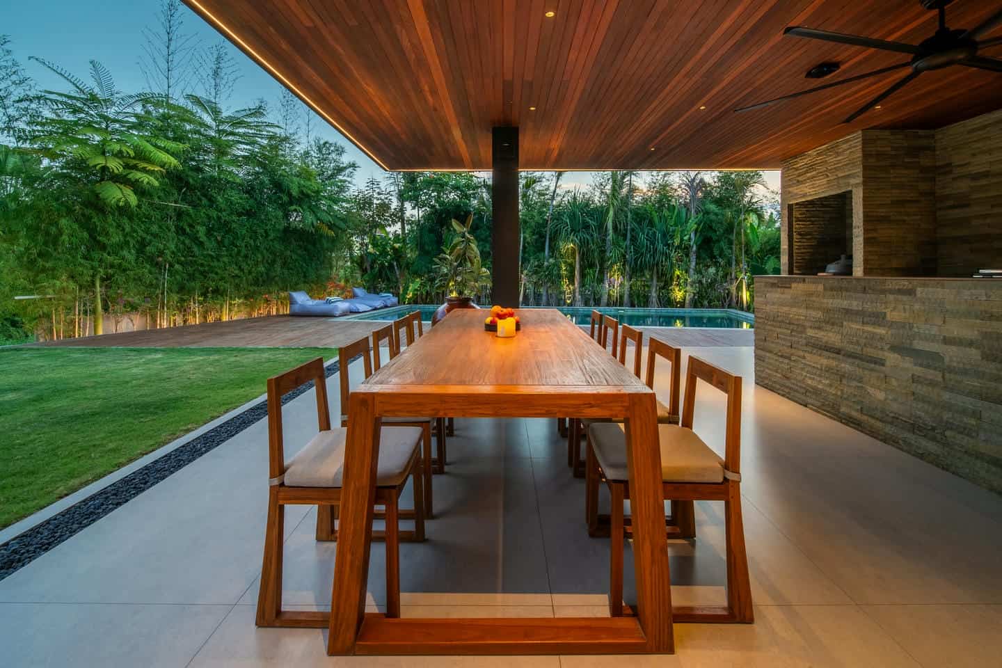 Outdoor dining area with wooden table and chairs.