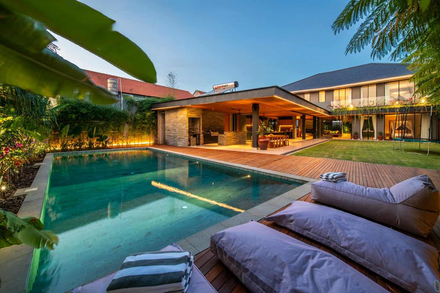 Modern villa with pool and outdoor seating area.