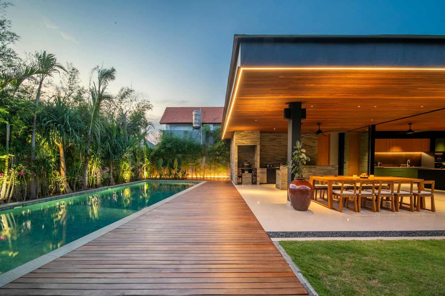 Modern villa with pool and outdoor dining area.