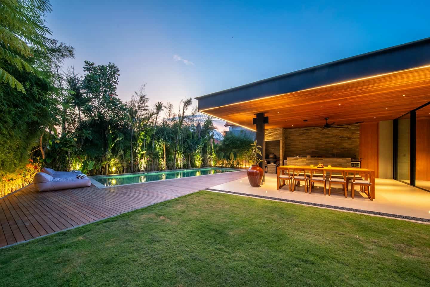 Modern backyard with pool and patio dining area.