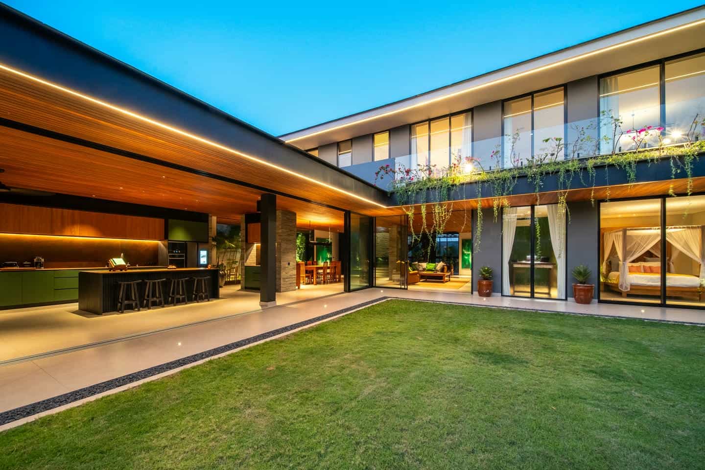 Modern two-story house with large windows.