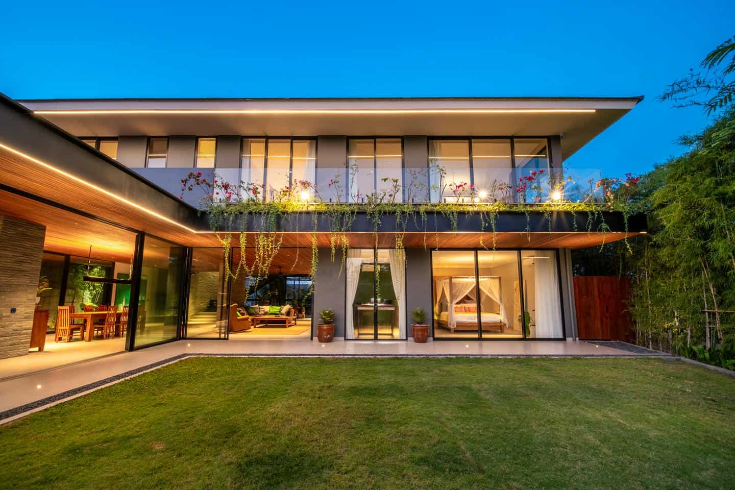 Modern house exterior with garden at dusk.