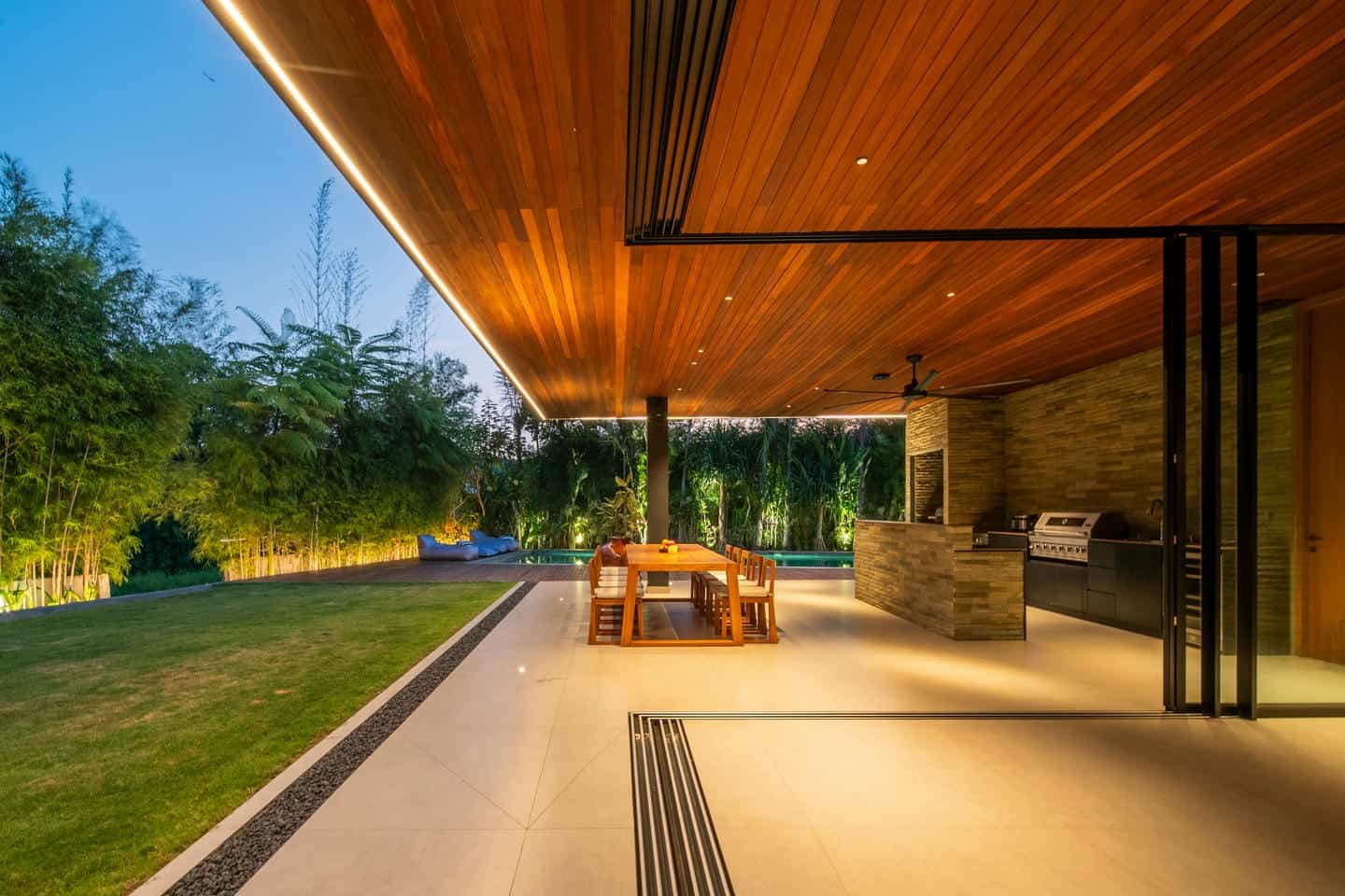 Modern patio with dining area and garden view.