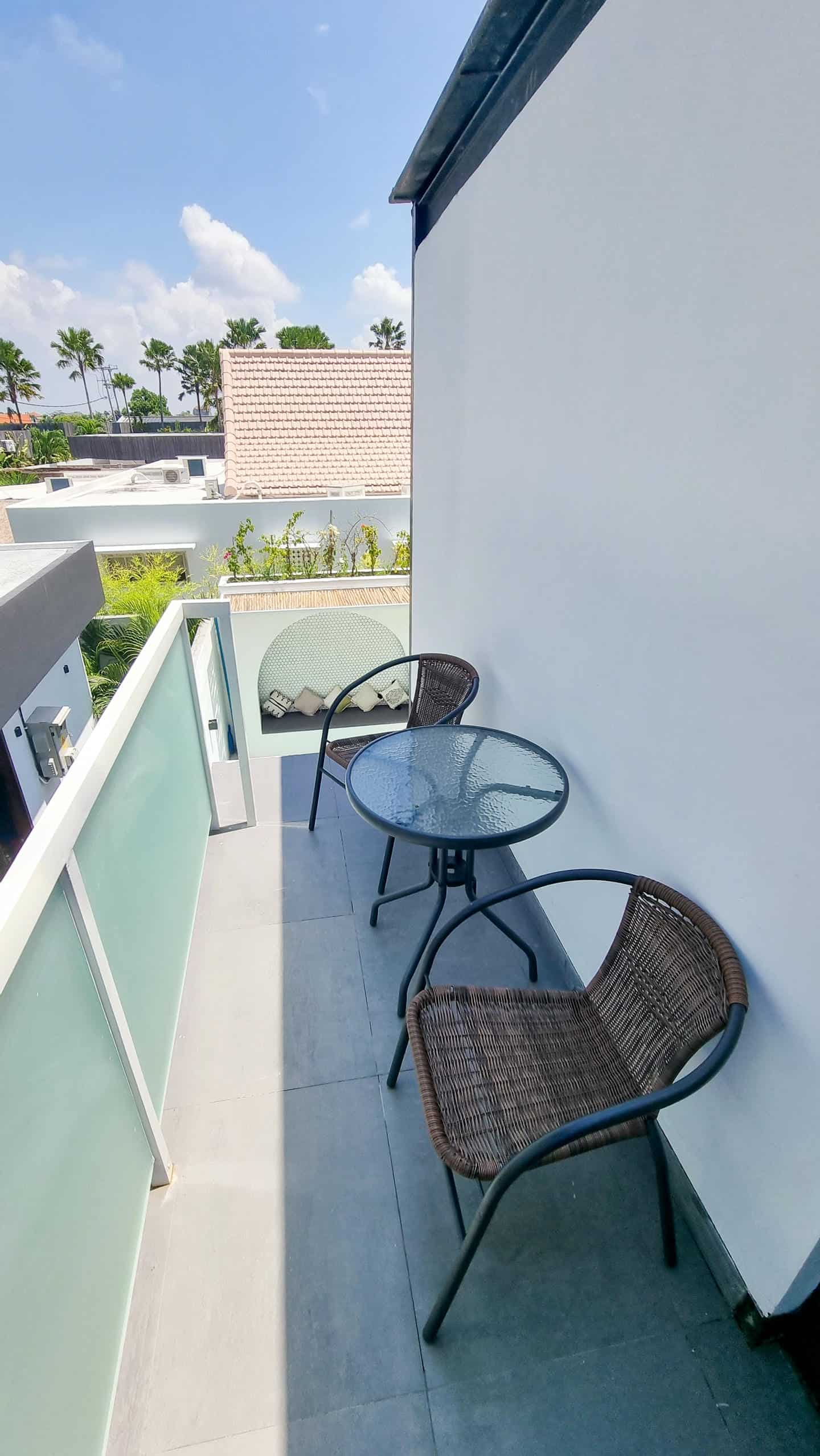 Small sunny balcony with chairs and table