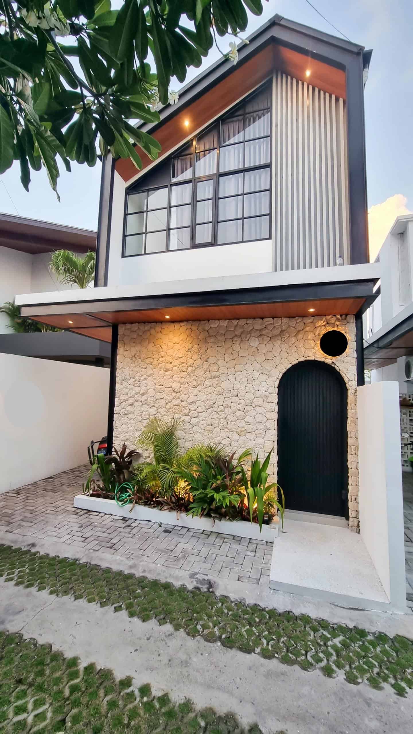 Modern house with stone facade and plants