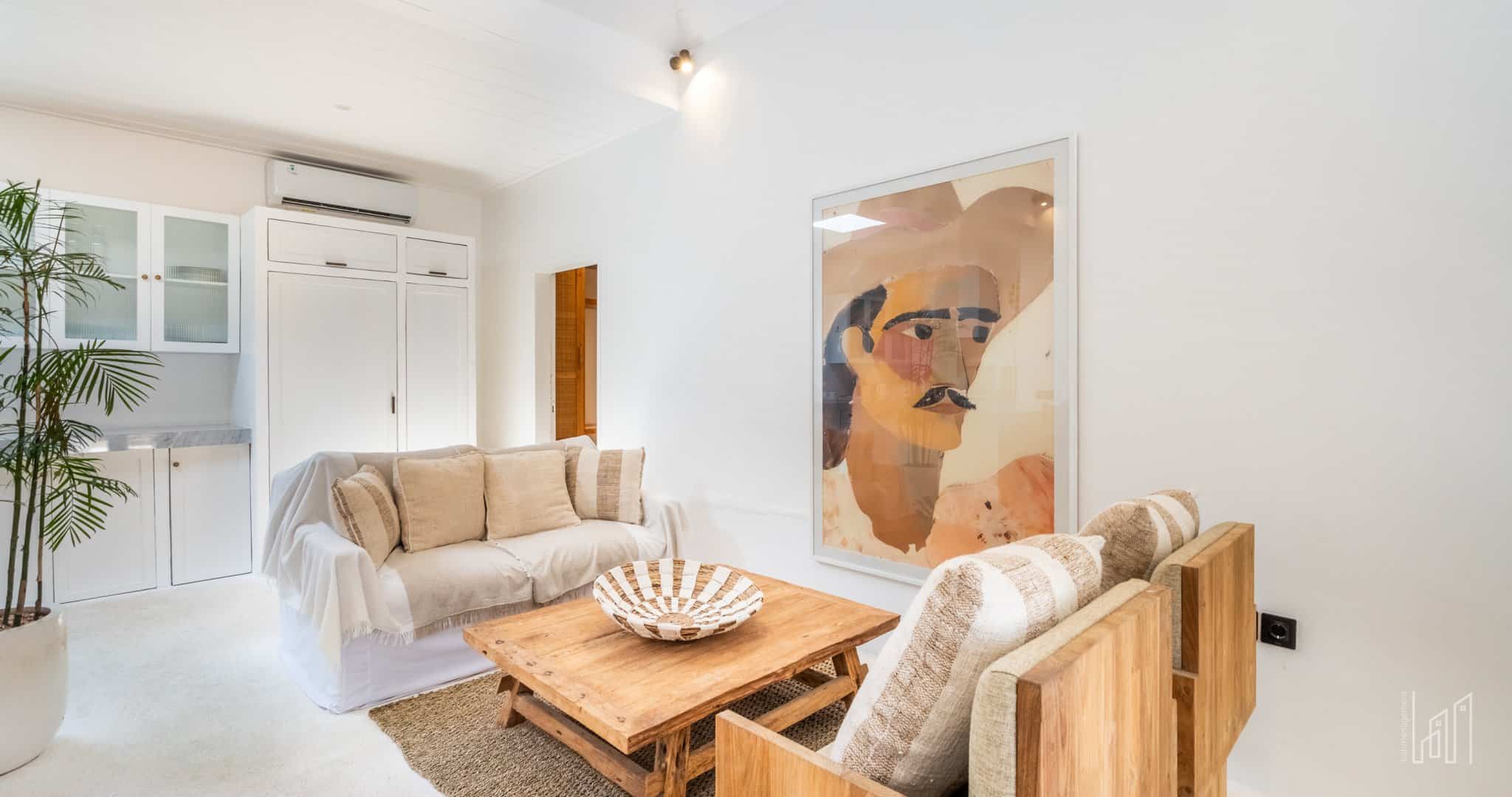 Cozy living room with modern art on wall.