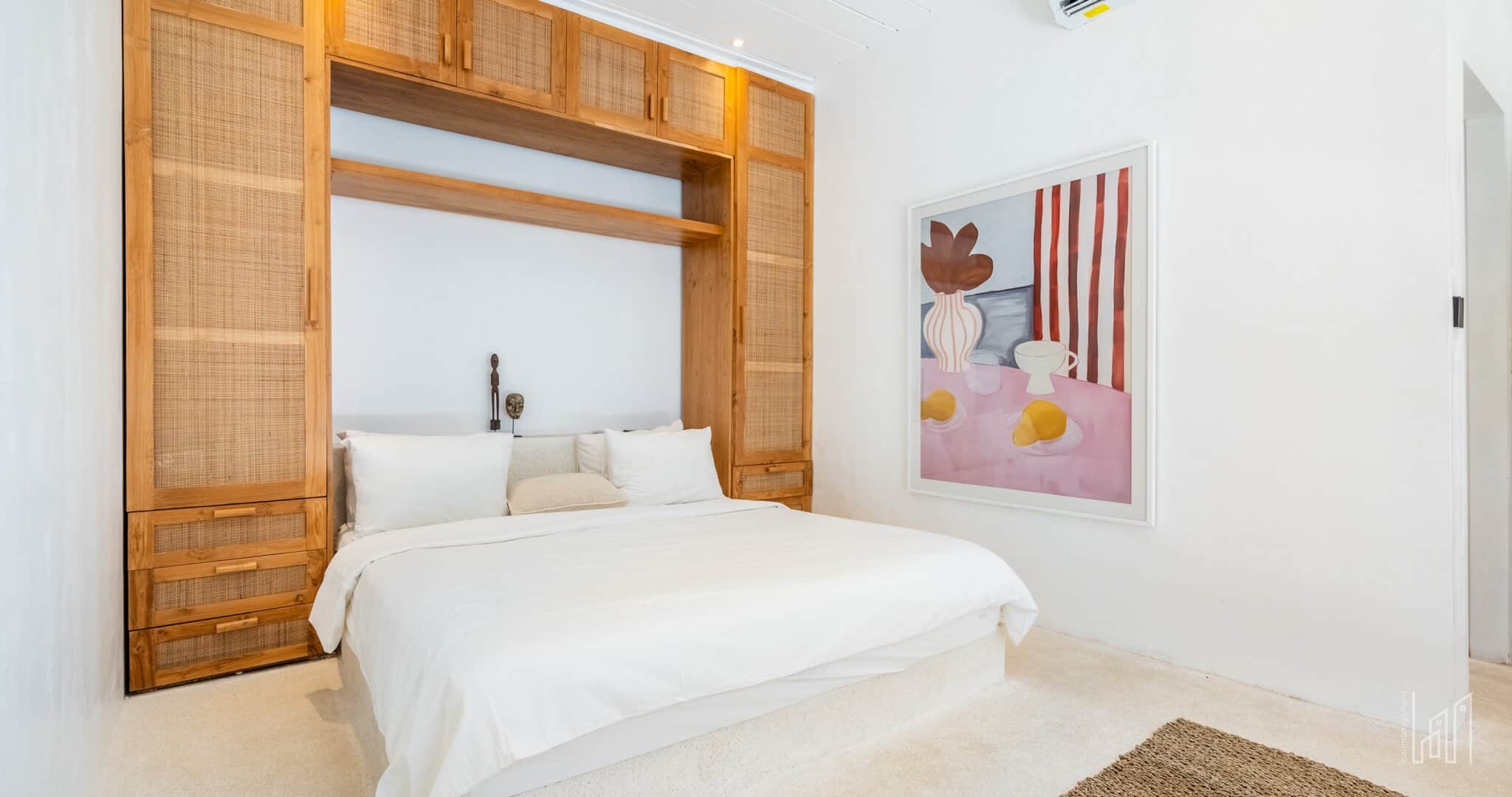 Modern bedroom with wooden furniture and abstract art