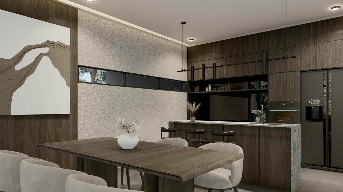 Modern kitchen with wooden table and black appliances.