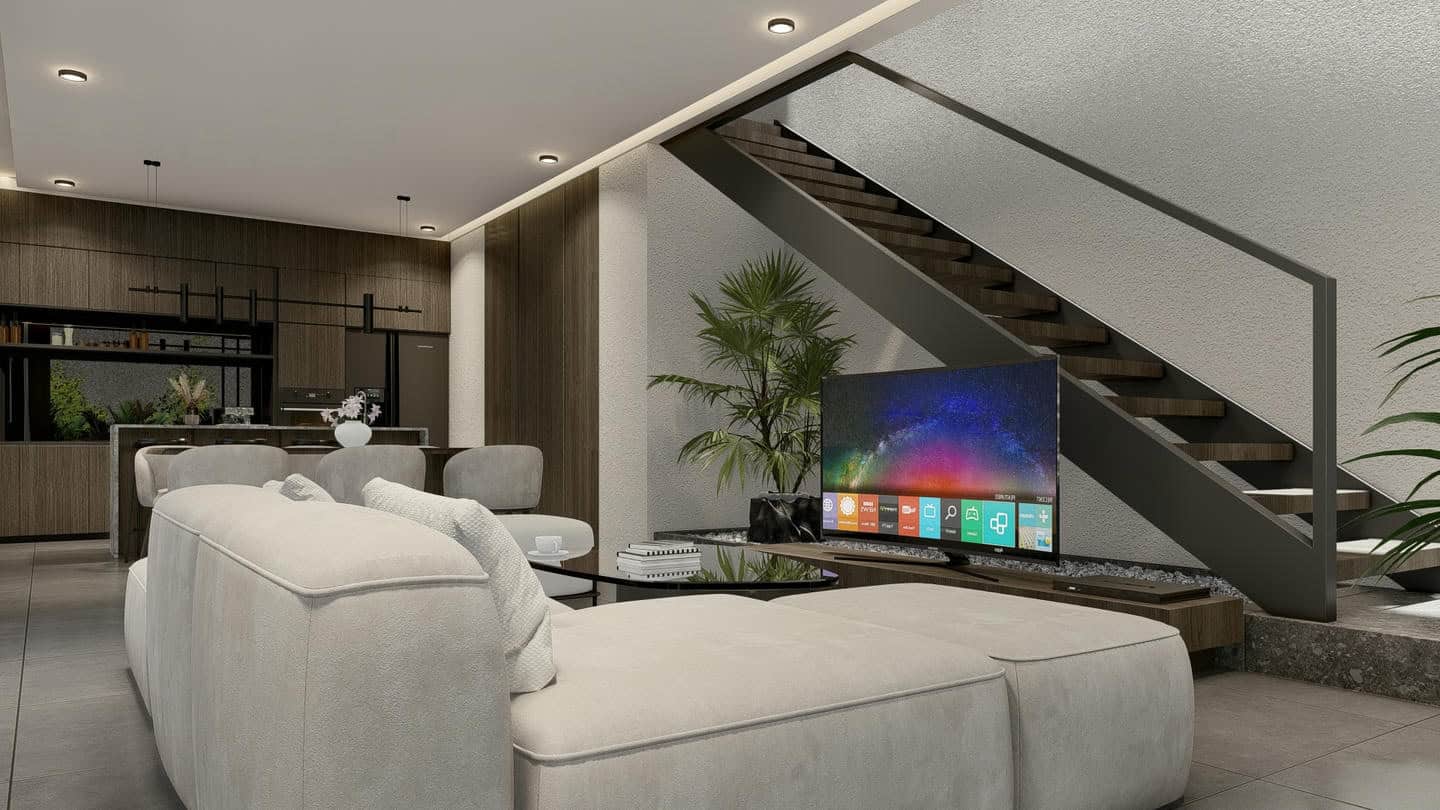 Modern living room with stairs and smart TV.