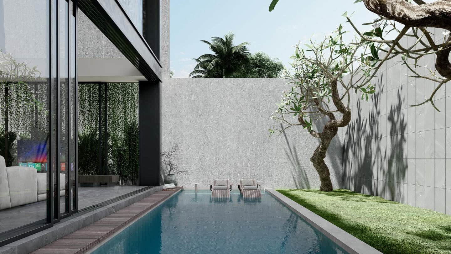 Modern poolside with lounge chairs and greenery.