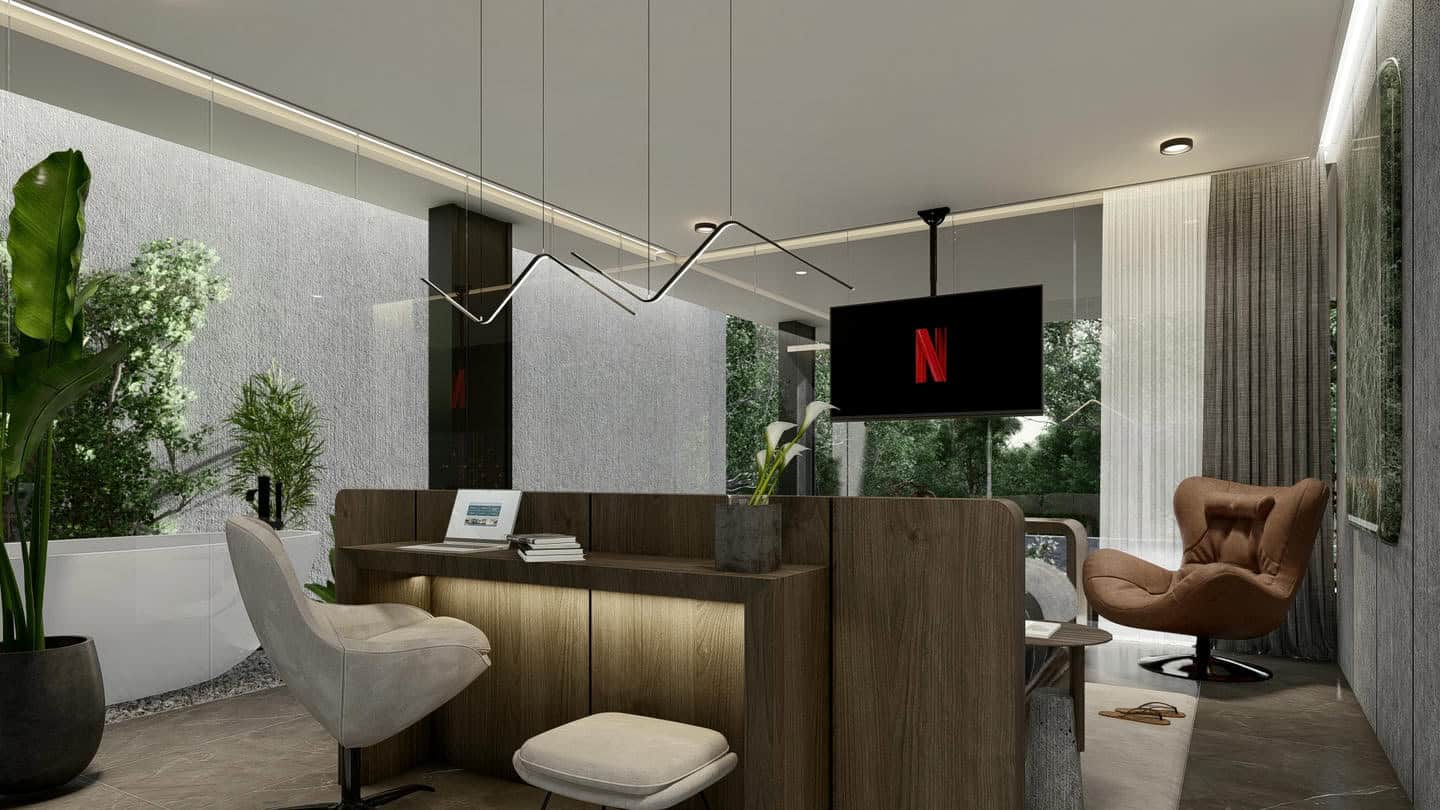 Modern home office with Netflix screen and plants.