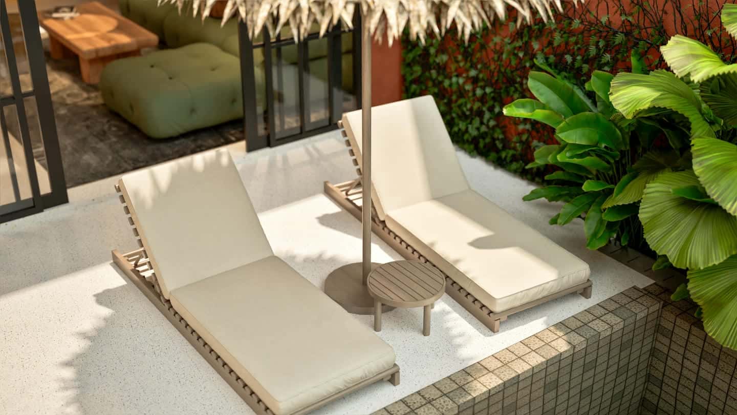 Outdoor lounge chairs by lush green plants