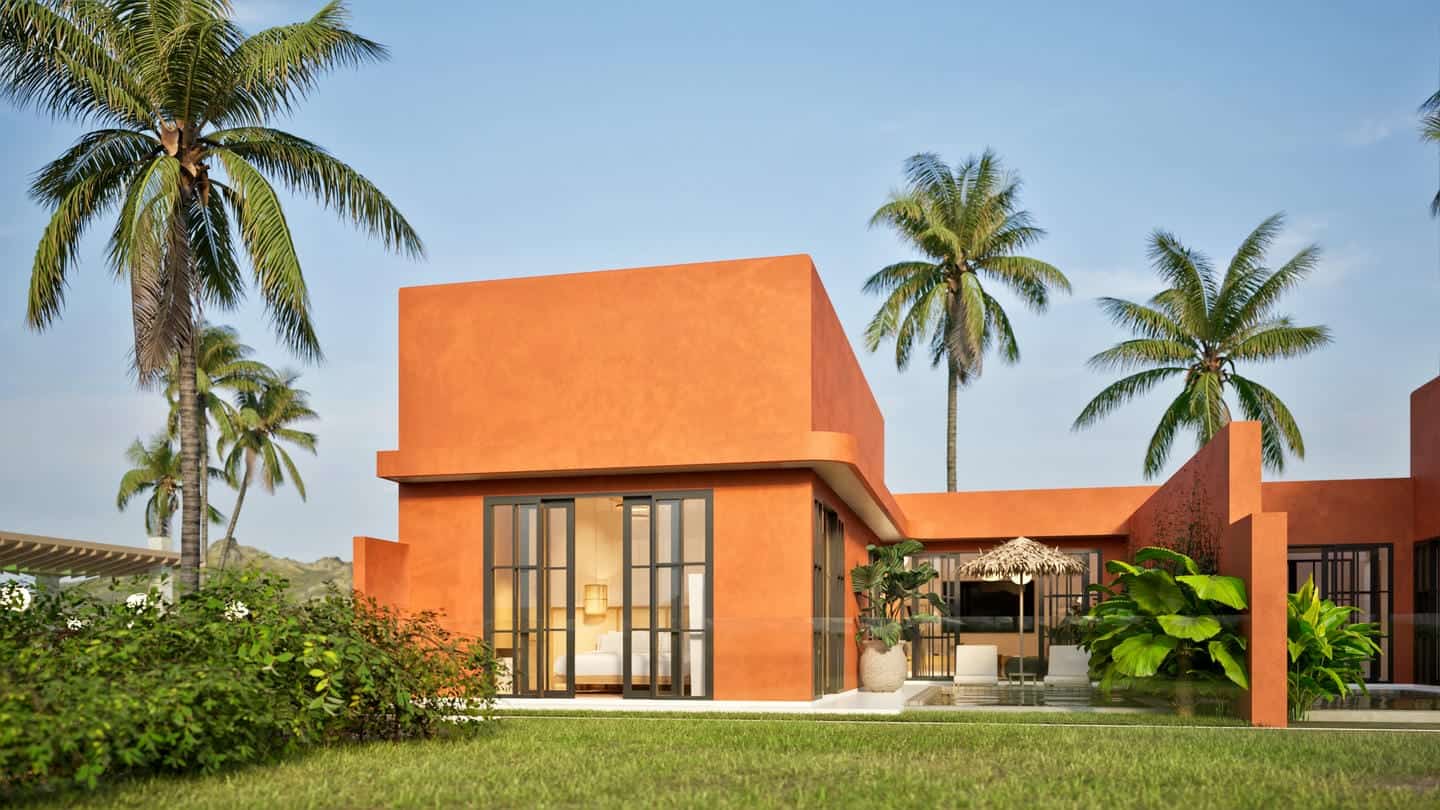 Modern orange villa with palm trees and pool.