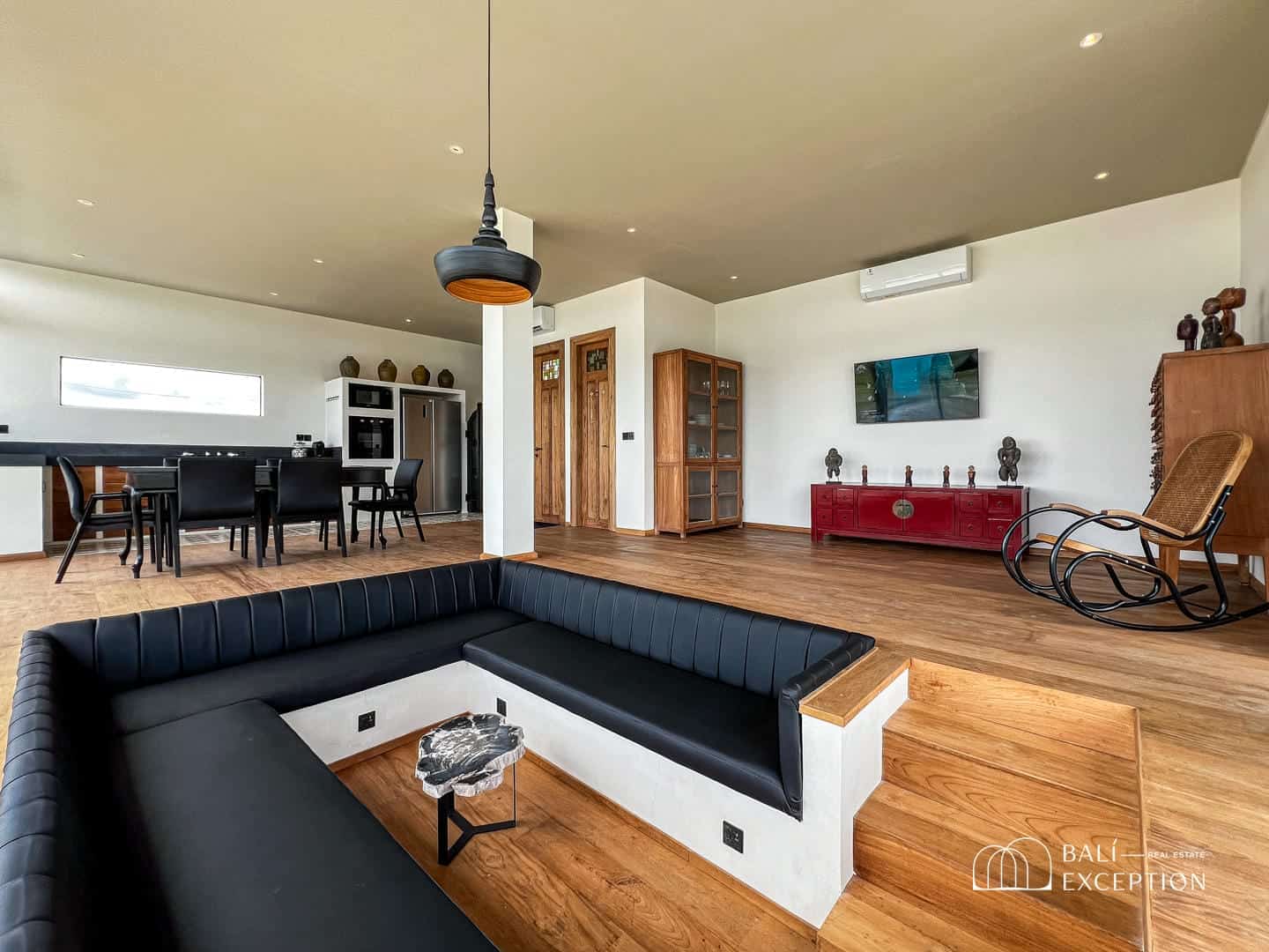 Modern living room with black furniture and wood accents