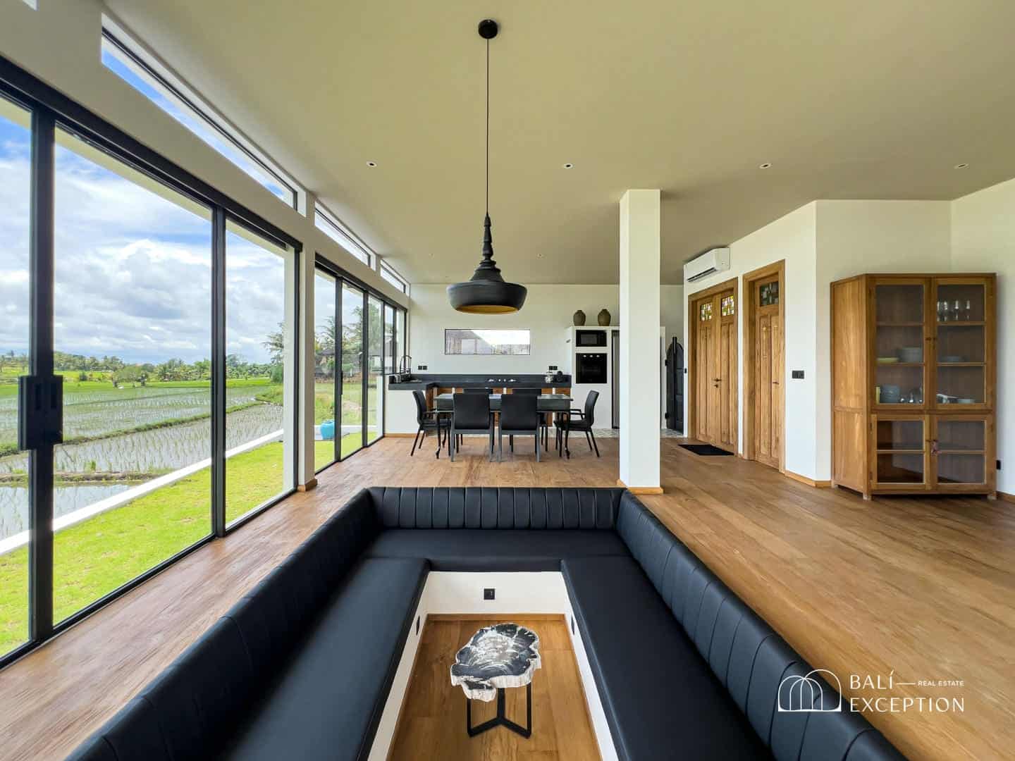 Modern living room with panoramic countryside view.