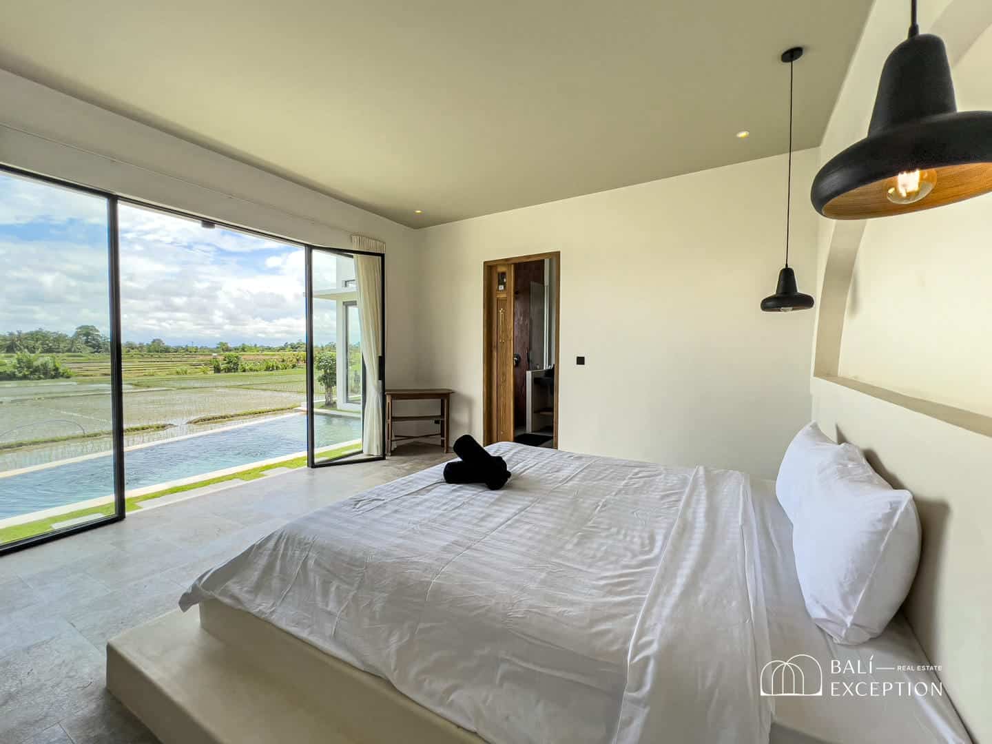 Modern bedroom with rice field view.