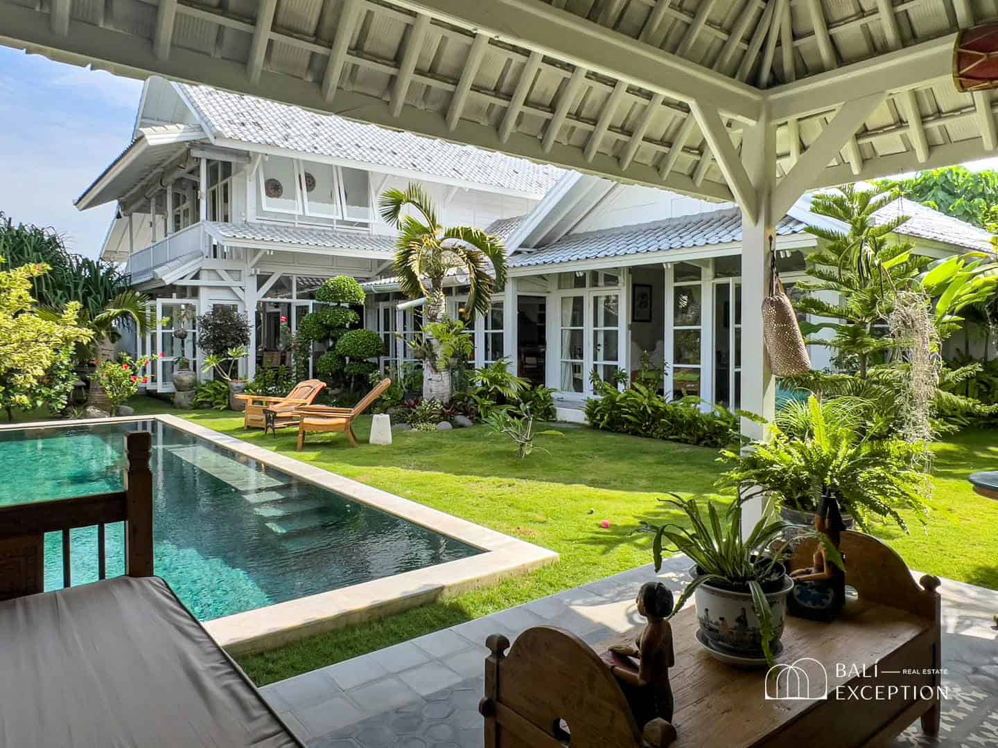 Luxurious villa with pool and tropical garden view.