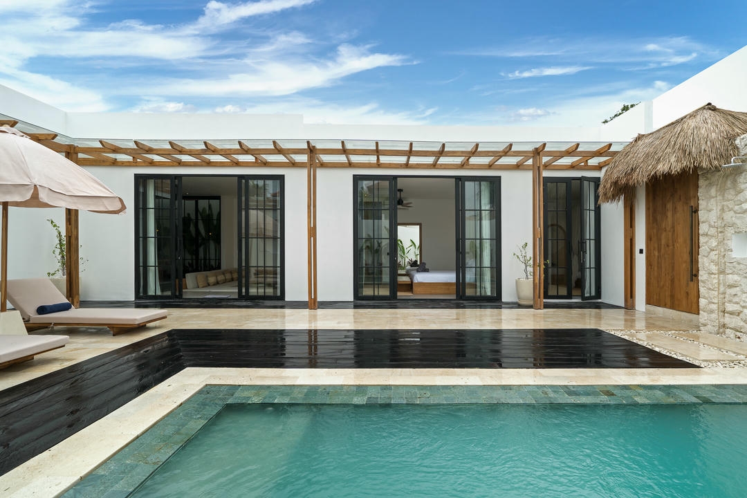 Modern villa with pool and sunny patio.