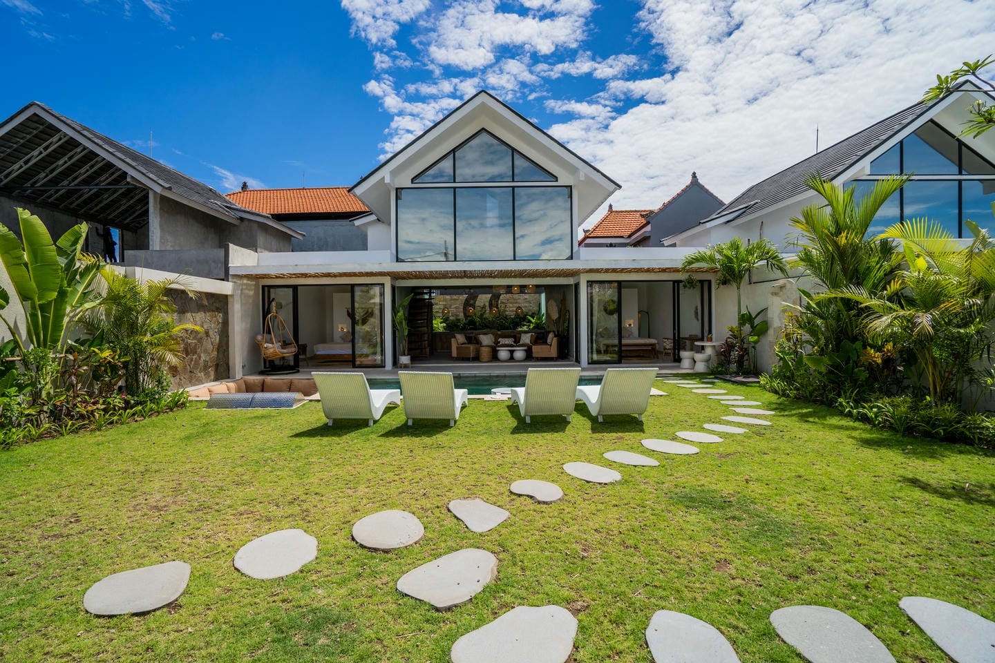Modern villa with lawn and sun loungers