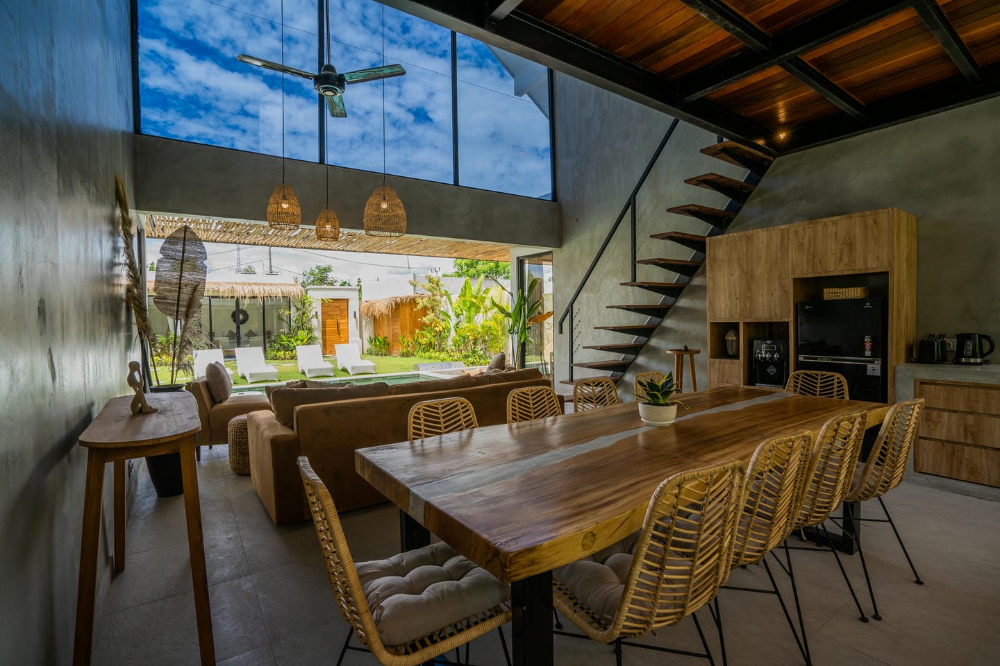 Modern living room with large windows and garden view.