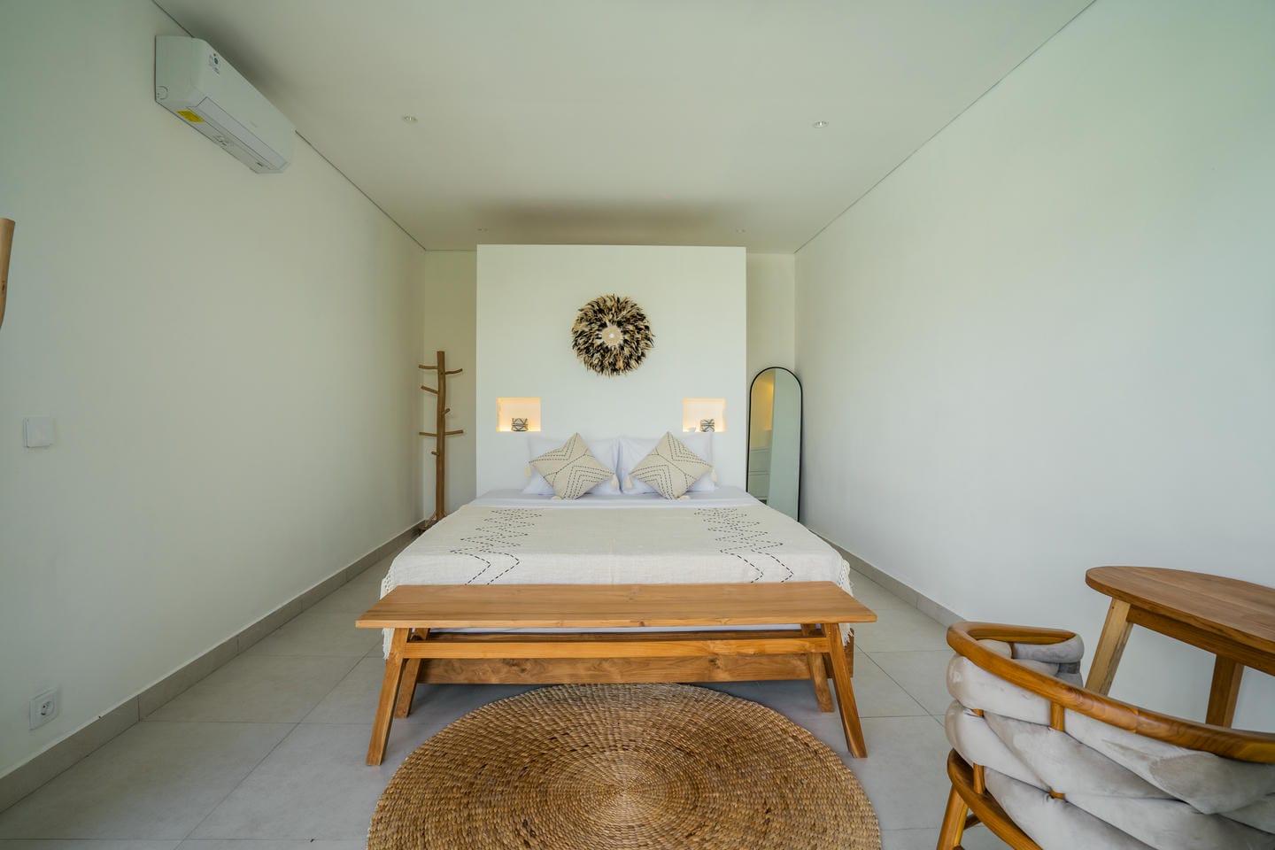 Minimalist bedroom with bed, chair, and decor