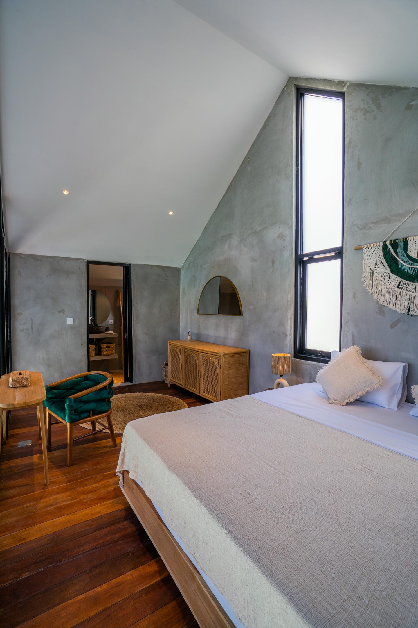 Modern bedroom with wooden floor and large windows.