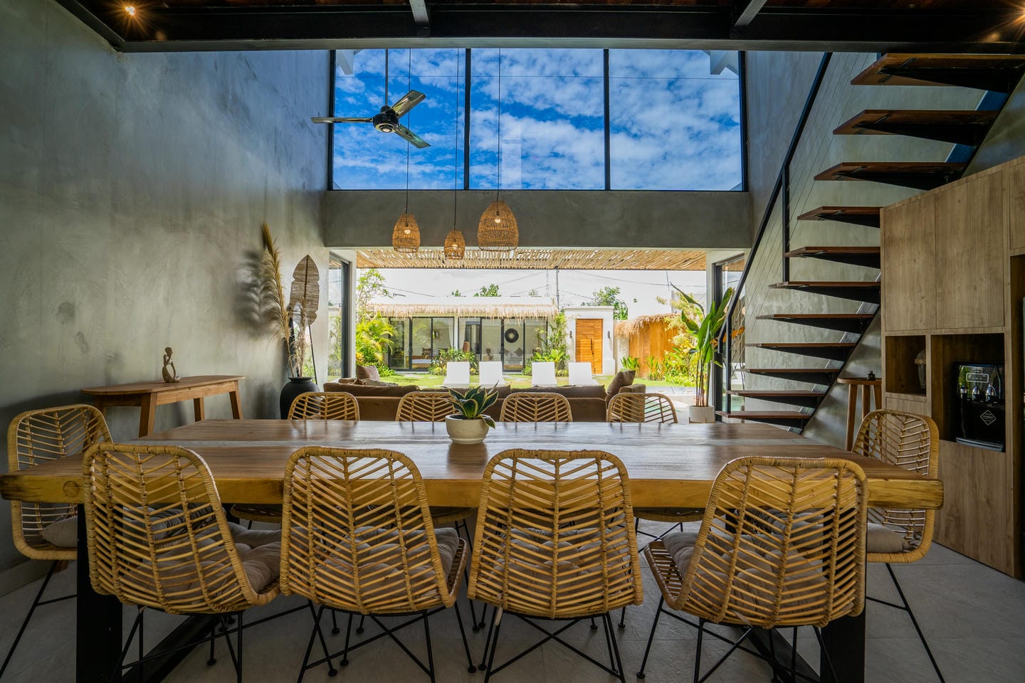 Modern dining room with wooden table and chairs.