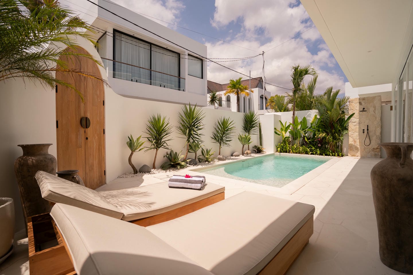 Luxurious villa with private pool and sun loungers.