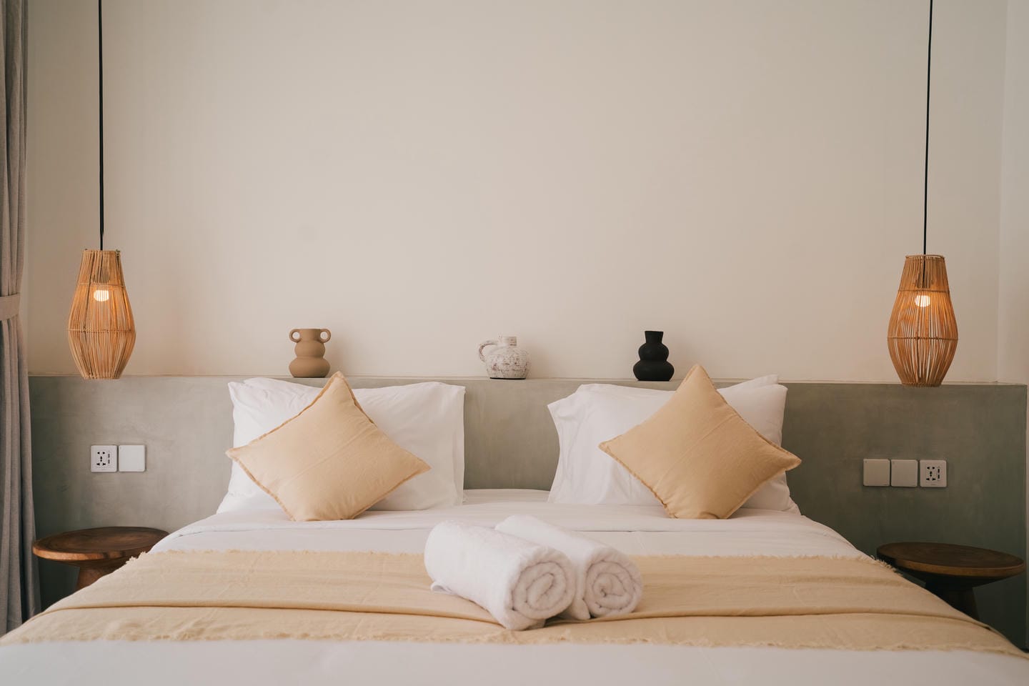 Cozy modern bedroom with neutral colors and decor.