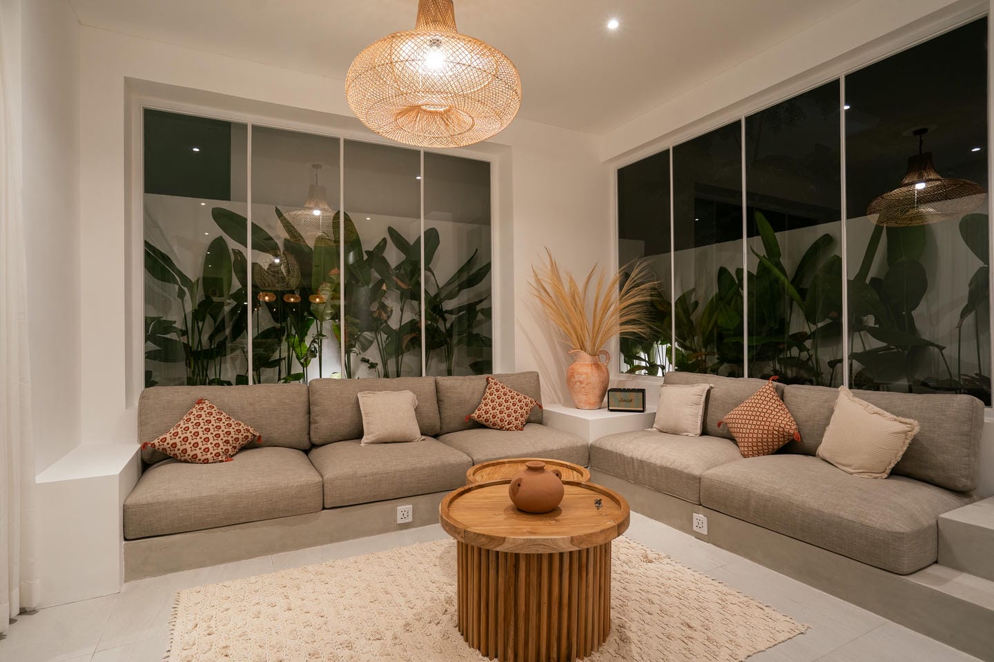 Modern living room with large windows and sofas.