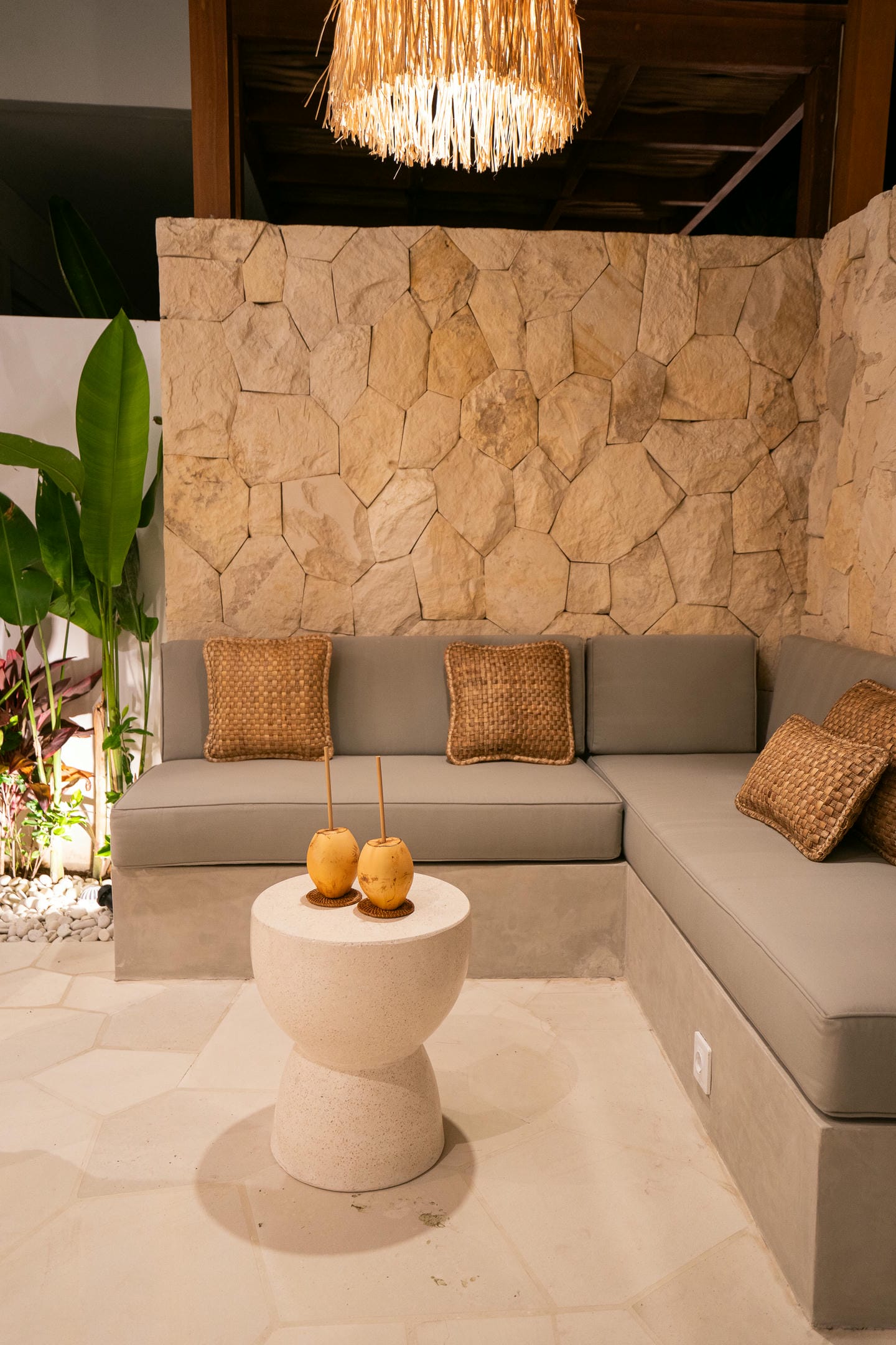 Cozy outdoor lounge with stone wall and seating