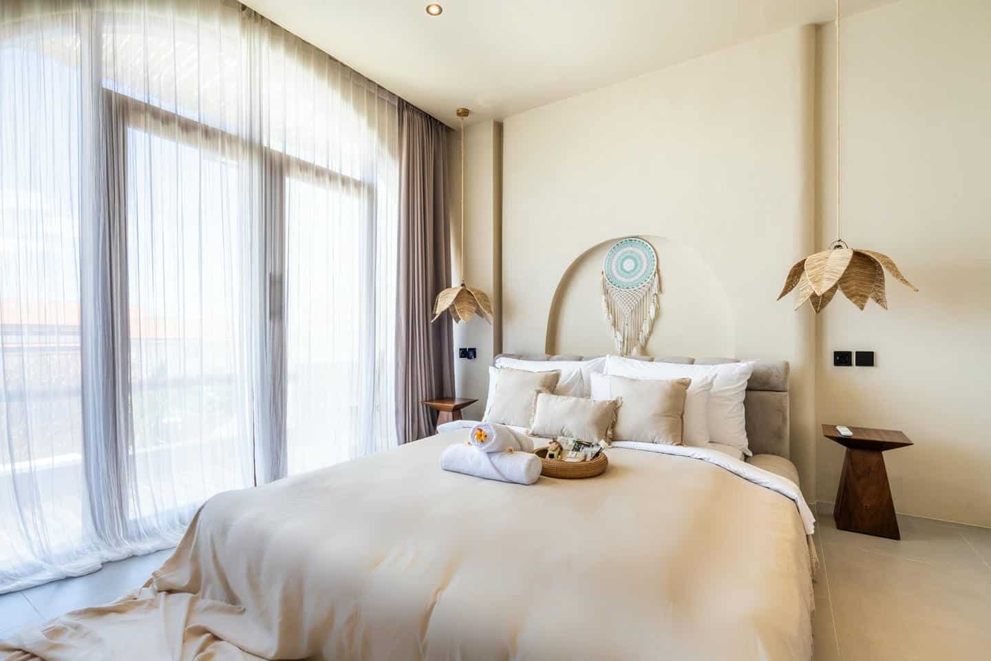 Serene bedroom with dreamcatcher and soft lighting