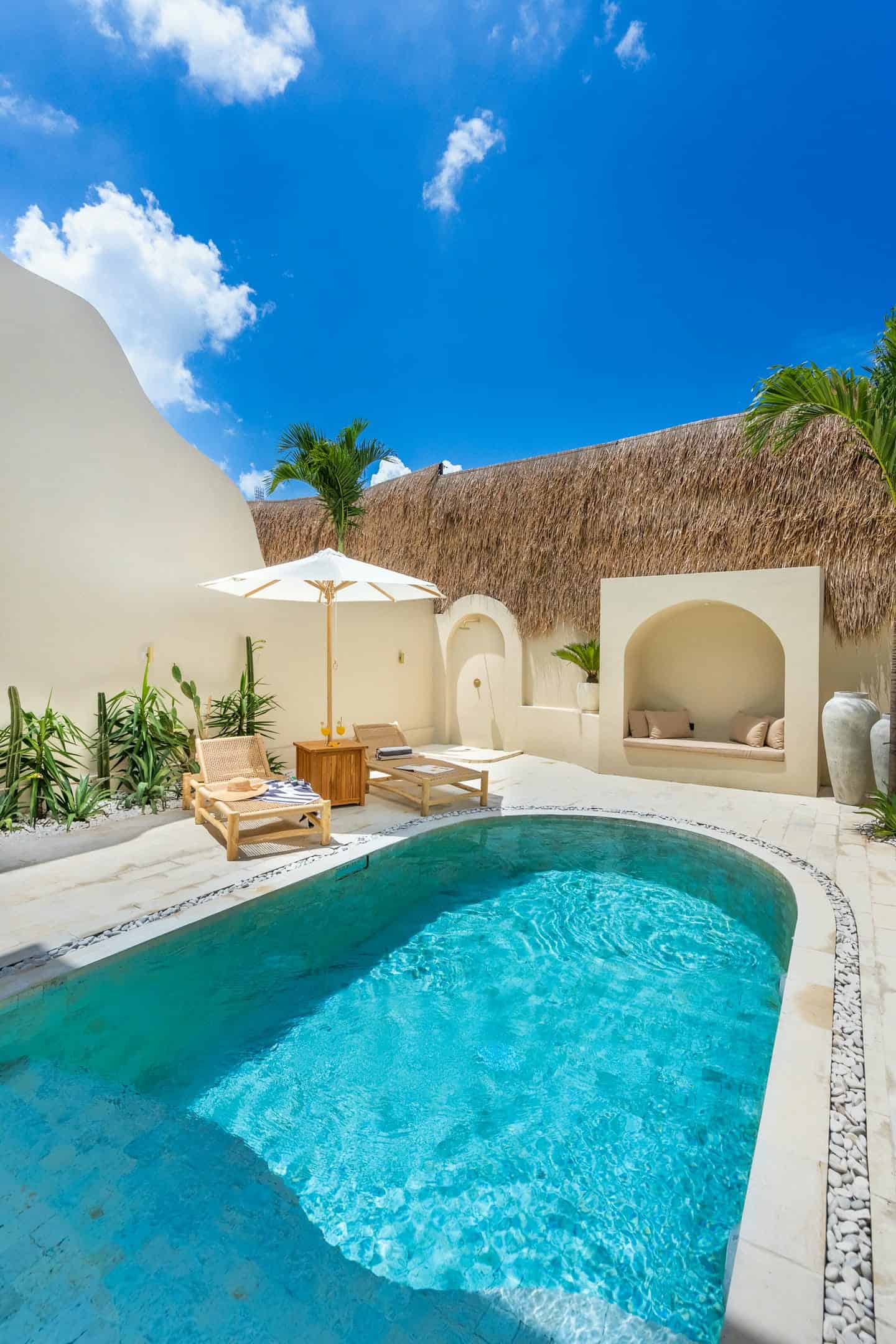 Luxury outdoor pool with lounge chairs.