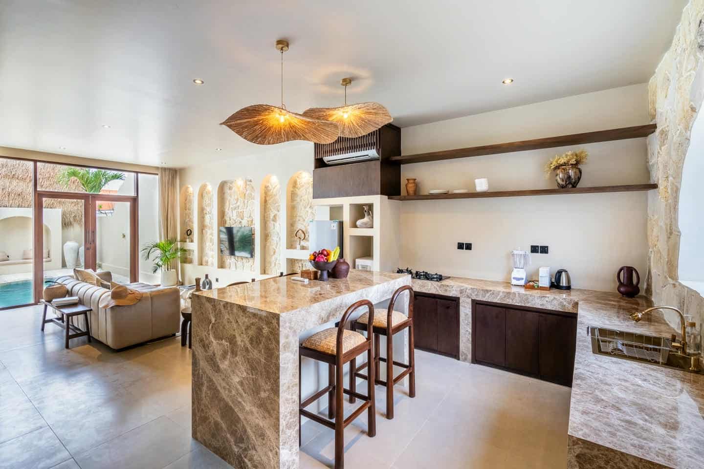 Modern open-concept kitchen and living room with pool.
