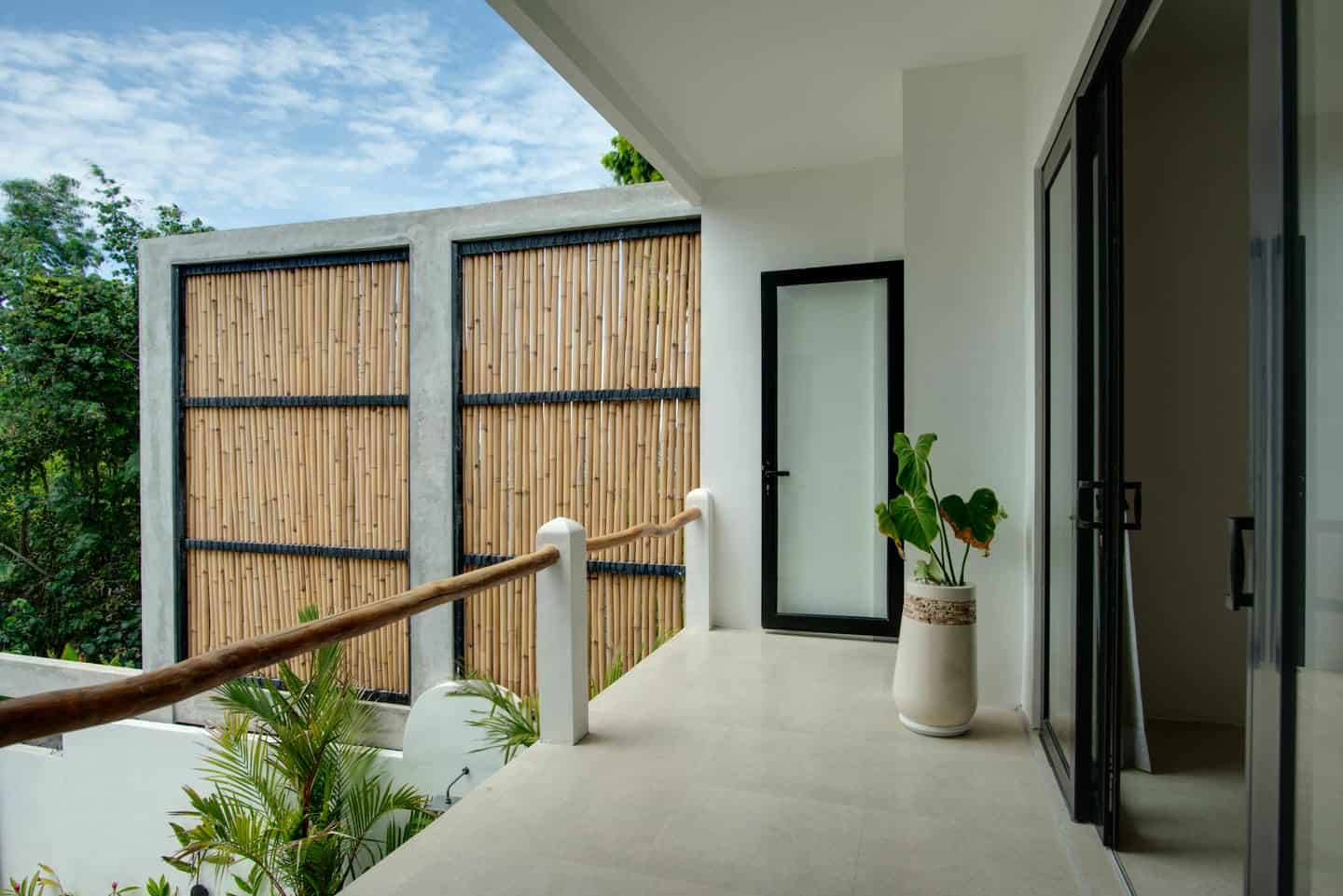 Modern balcony with bamboo privacy wall and plants