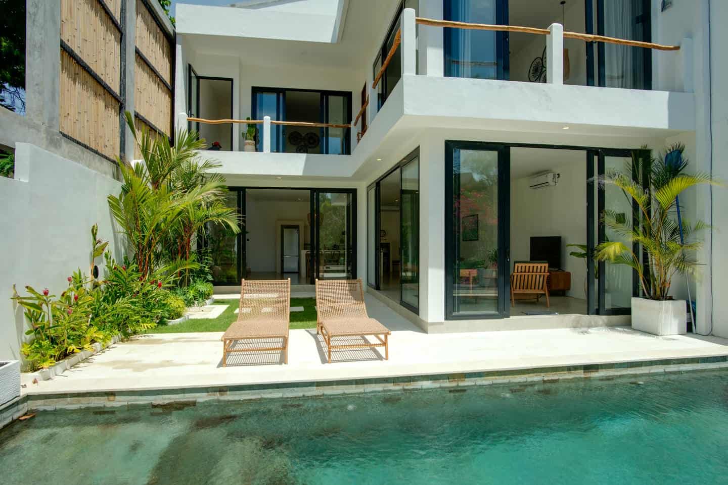 Modern villa with pool and lounge chairs