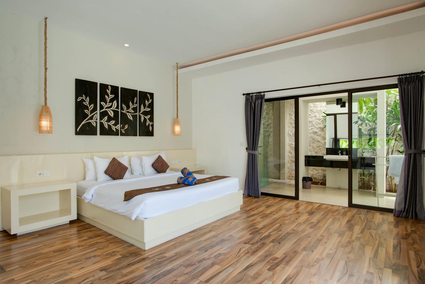 Modern bedroom with king bed and garden view.