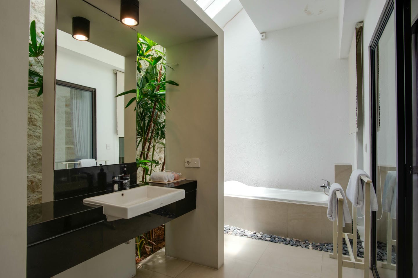 Modern bathroom with bathtub and plants