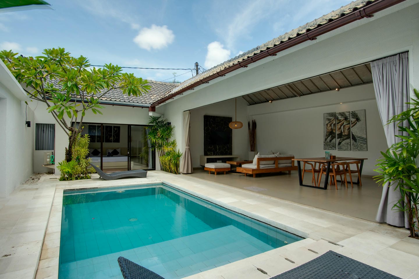 Spacious villa patio with pool and seating area.