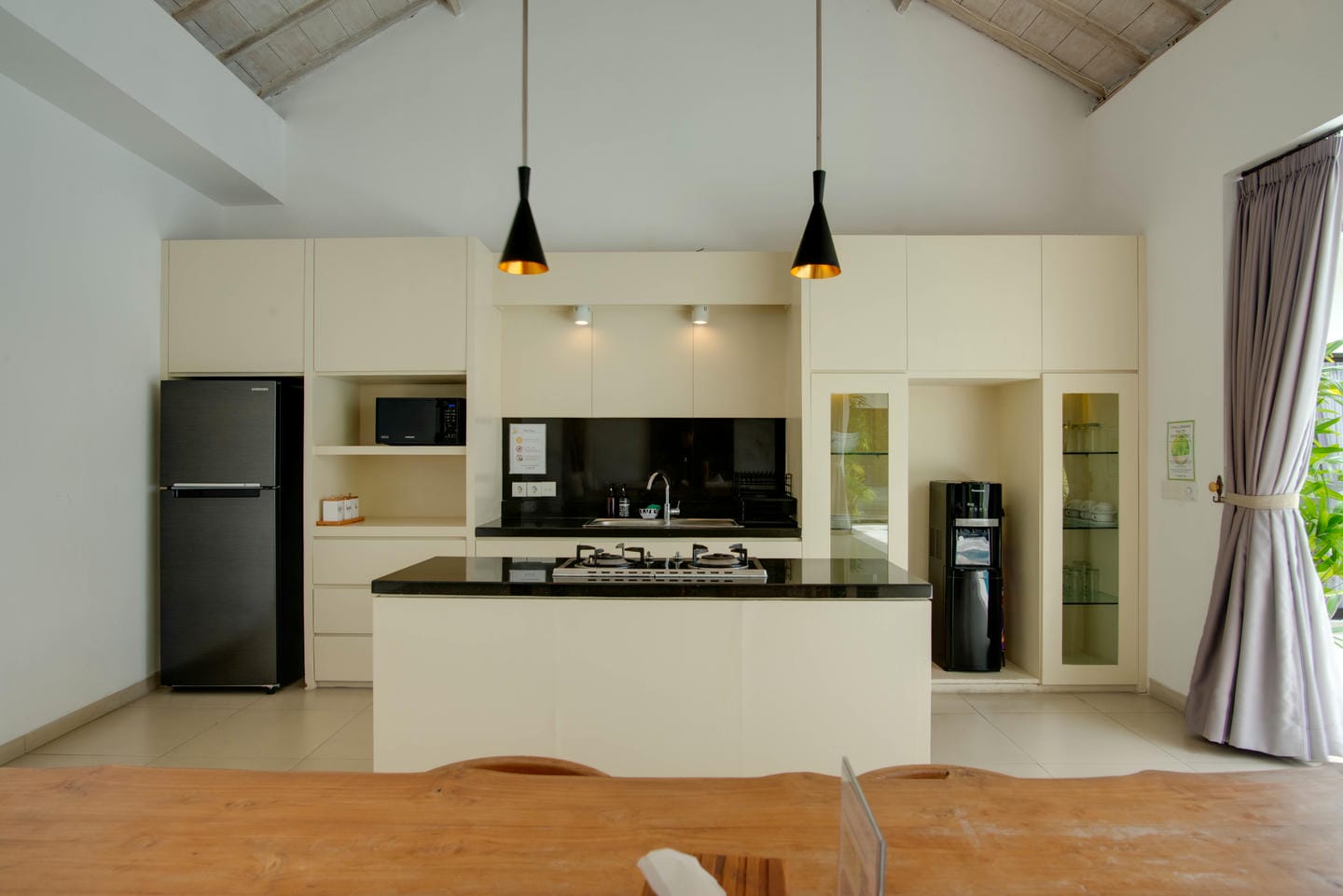 Modern kitchen with appliances and wooden dining table