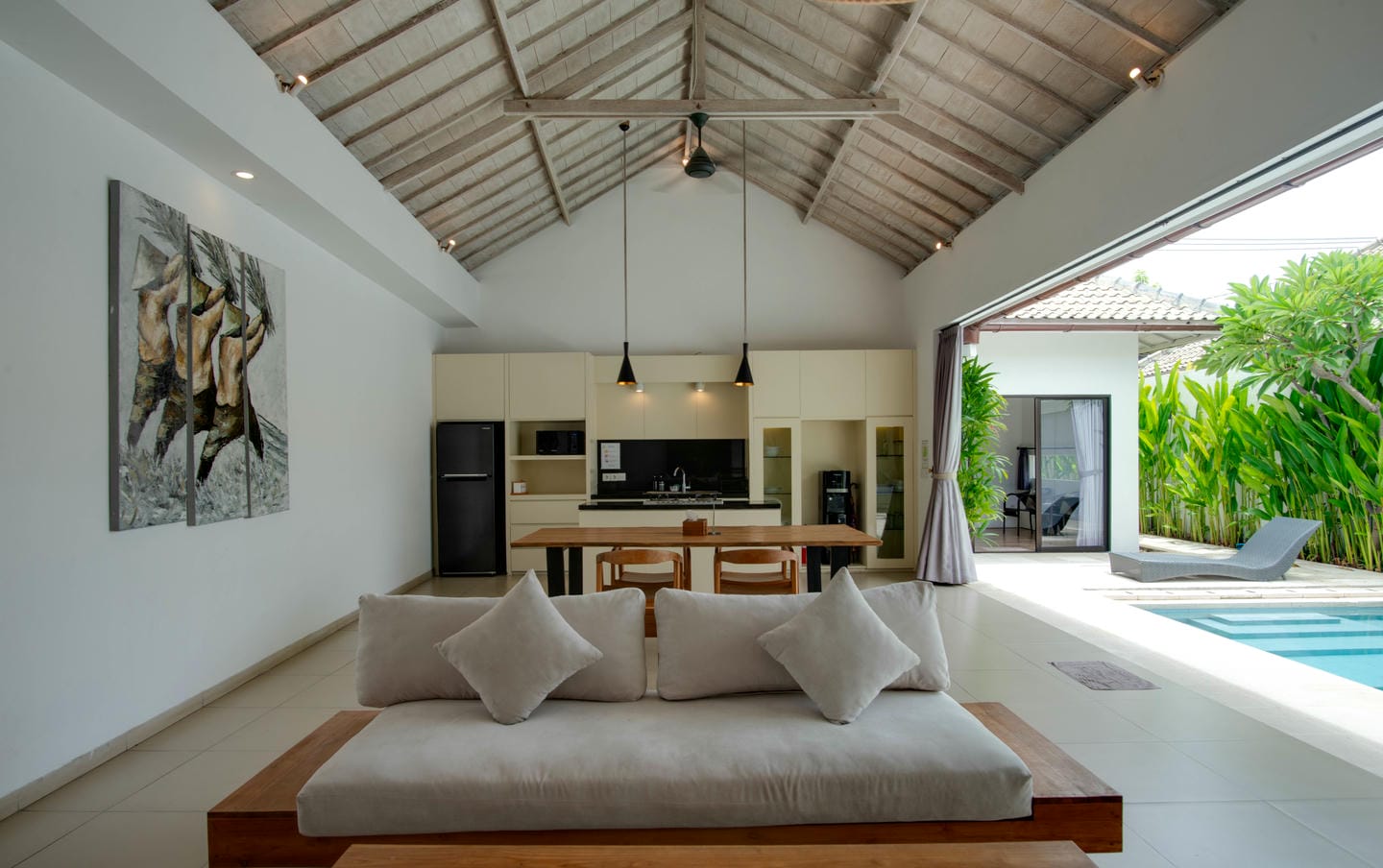 Open-concept villa with pool and modern kitchen area.