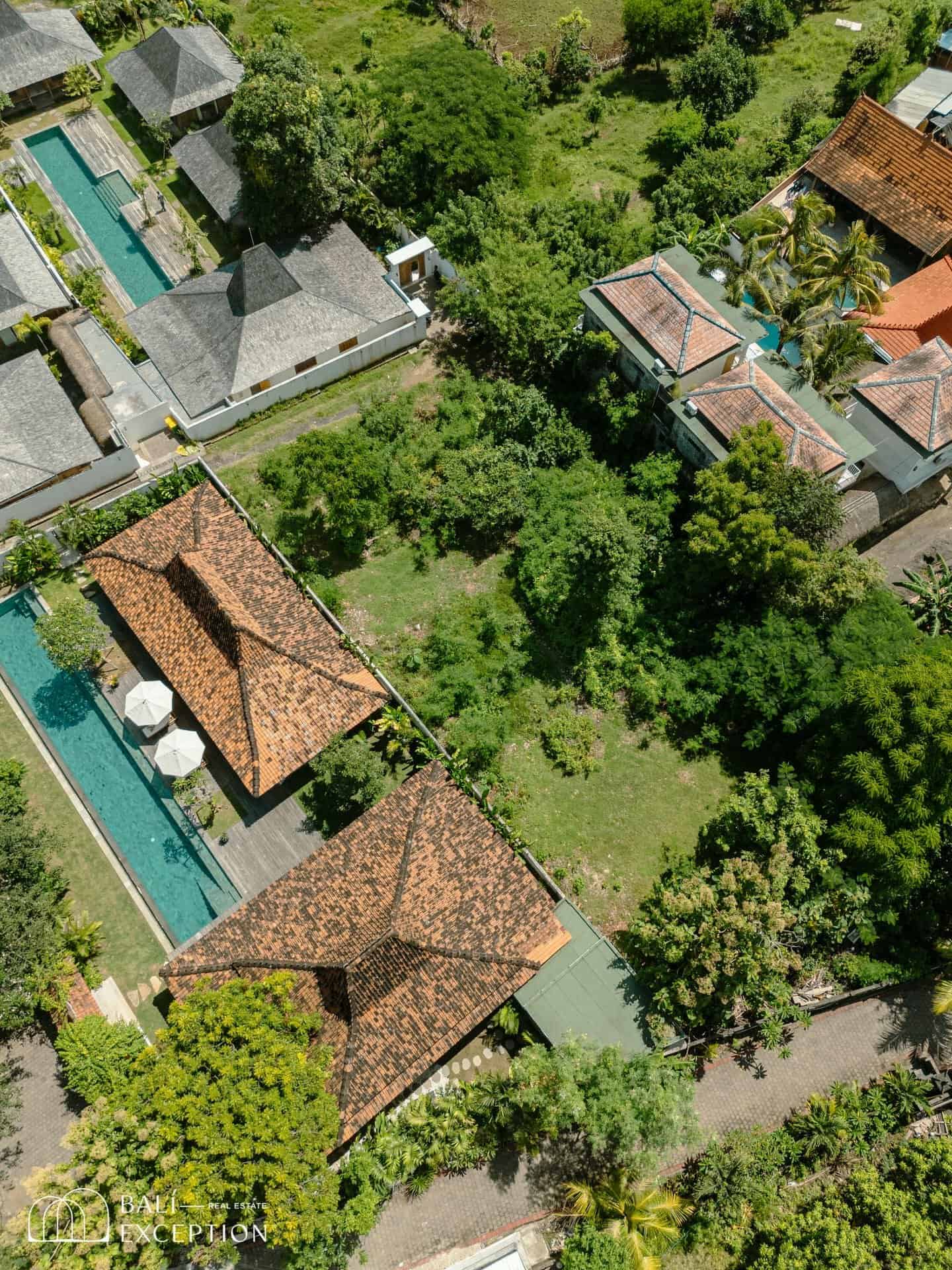 Aerial view of resort with villas and pool.