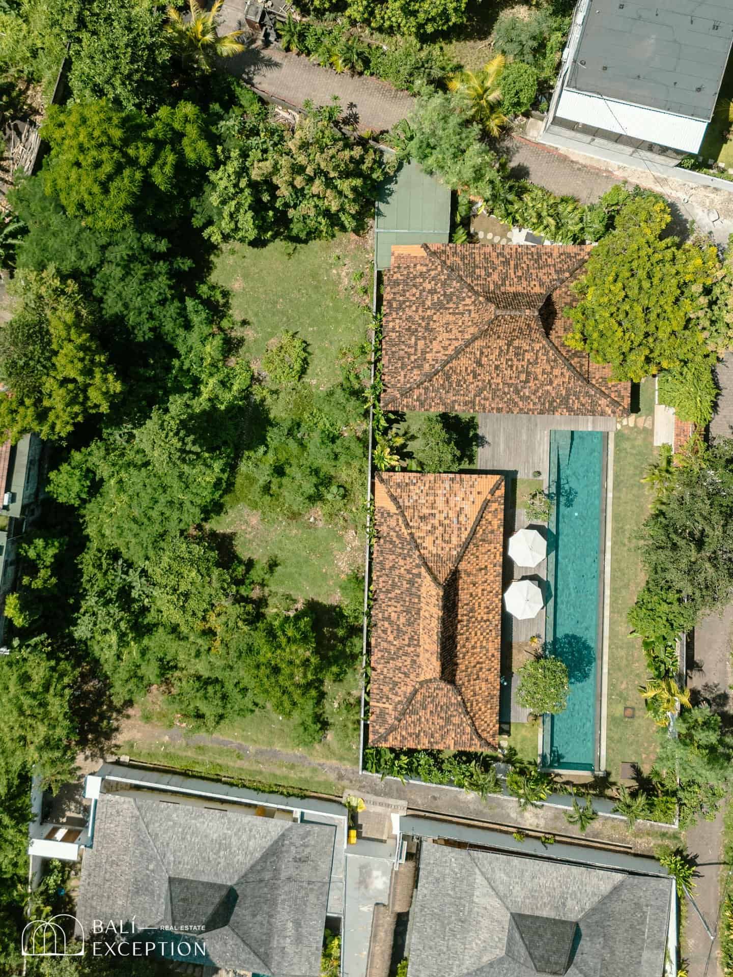 Aerial view of villa with pool and garden.