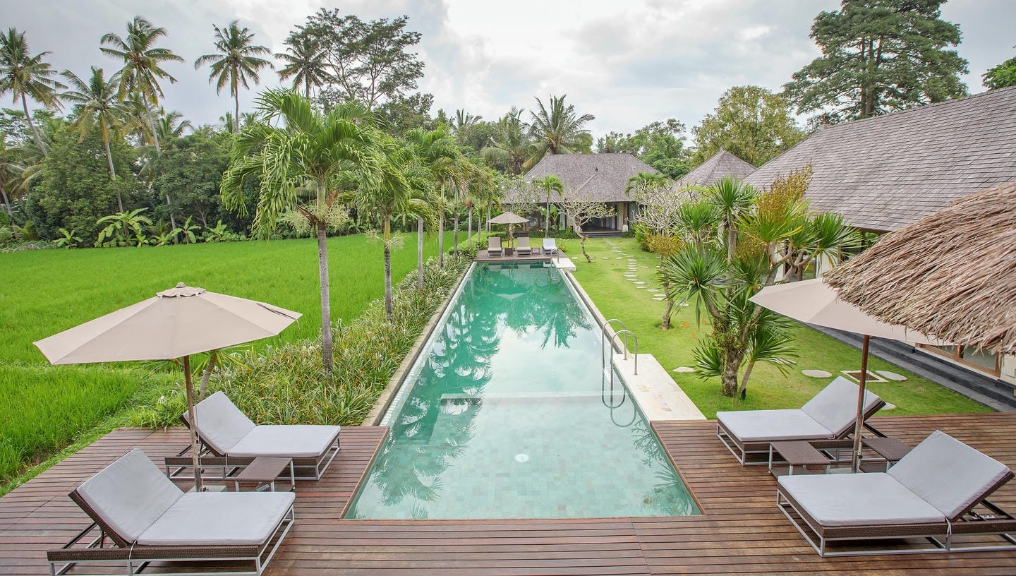 Tropical resort with pool and palm trees in Bali