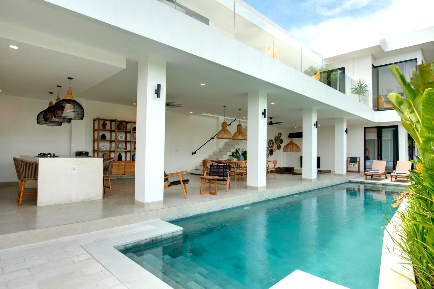 Modern villa with pool and outdoor seating.