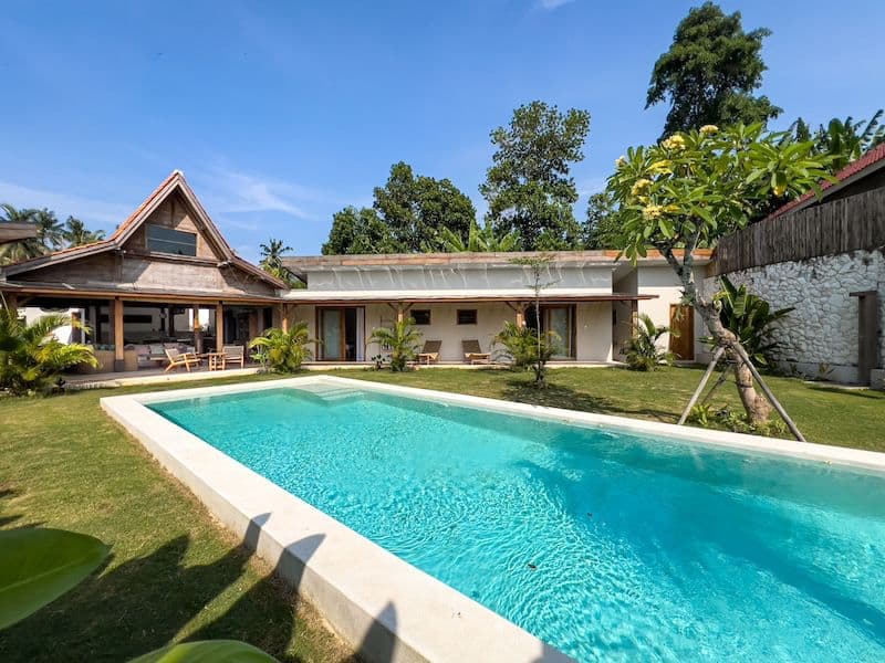 Modern house with outdoor pool and garden view.