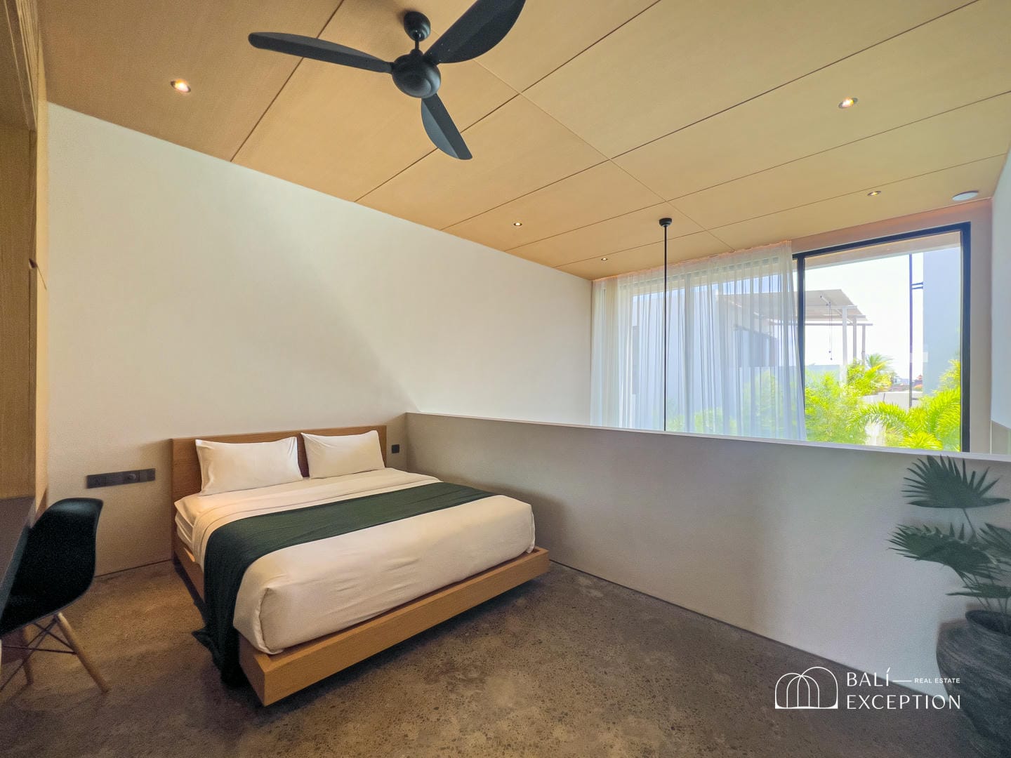 Modern bedroom with large window and ceiling fan.