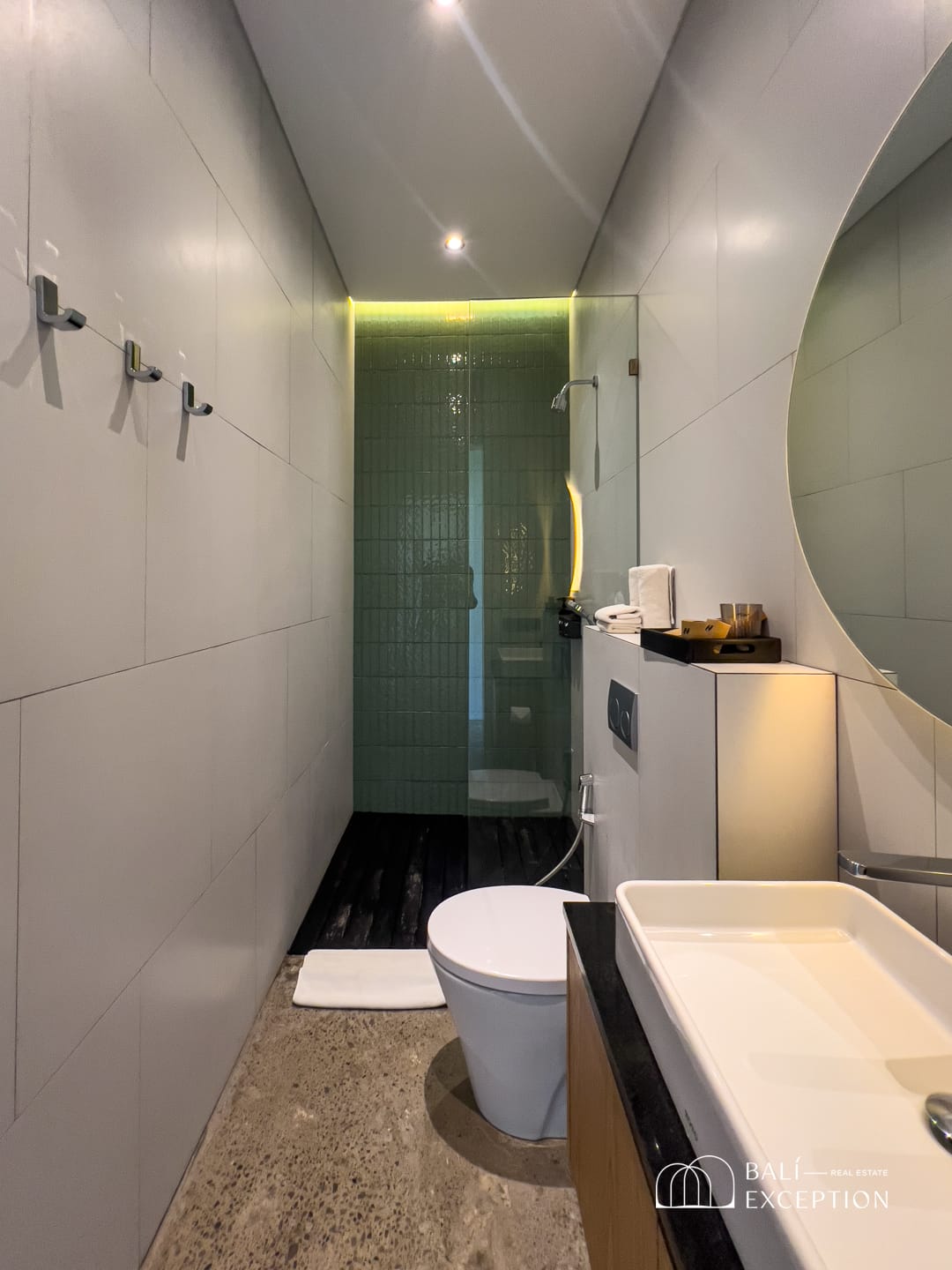 Modern bathroom with toilet, sink, and shower area