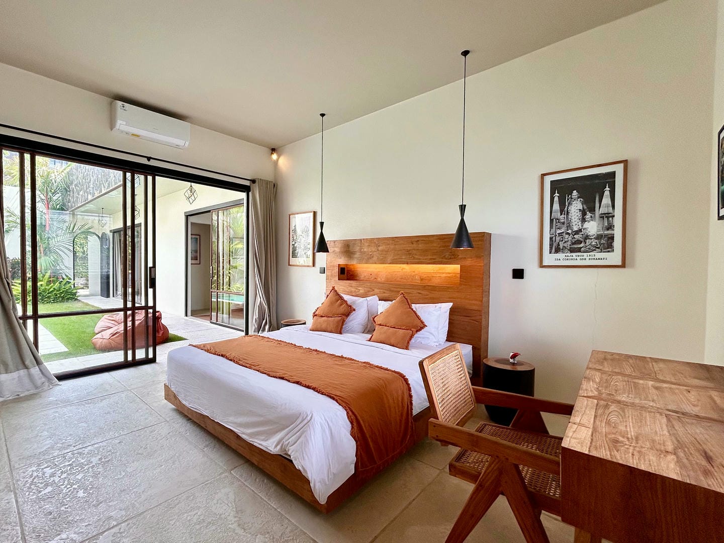 Modern bedroom with garden view and wooden furniture.