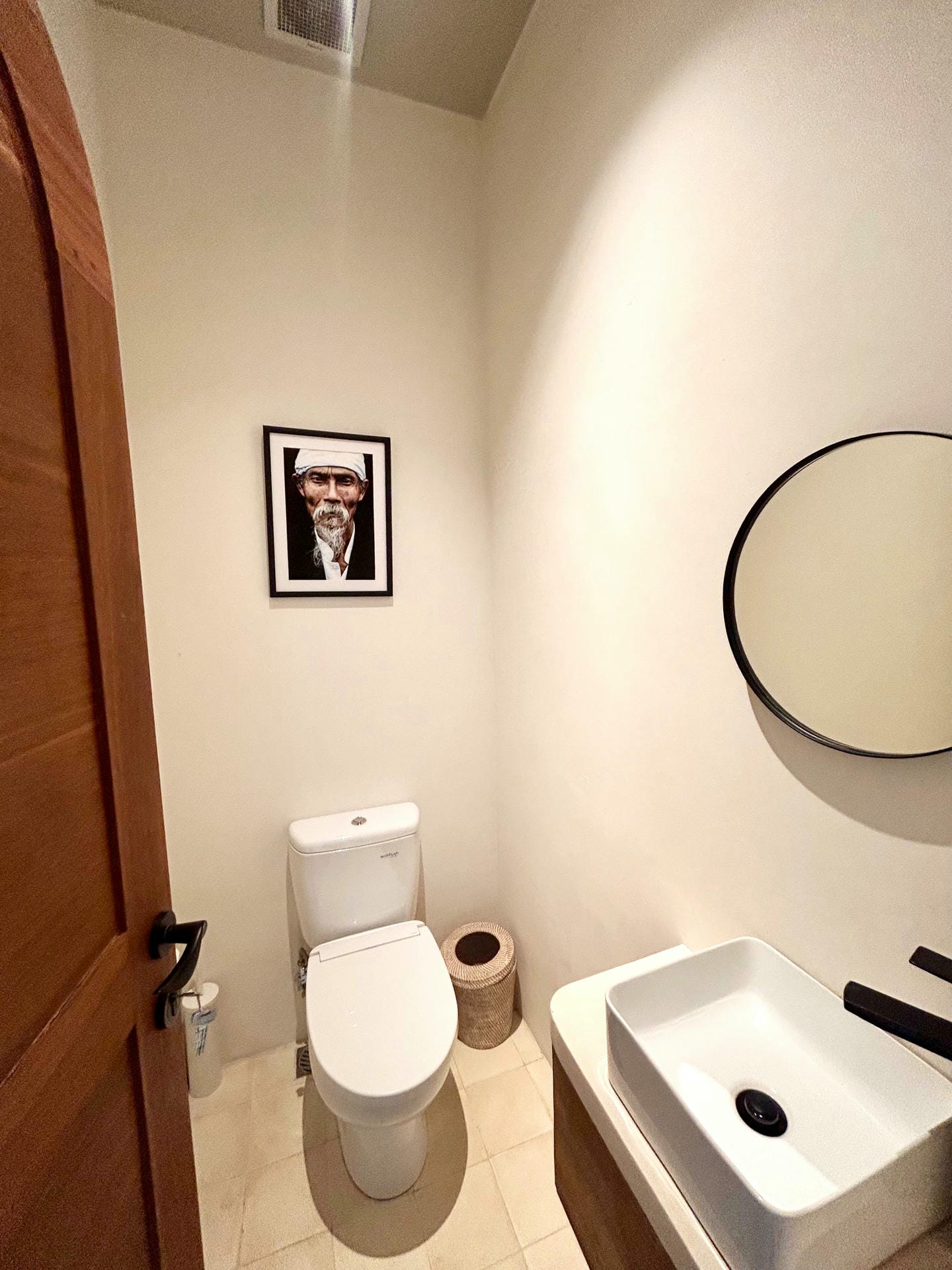 Minimalist bathroom with sink and toilet.